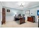 Bright home office with a wooden desk, paneled walls, and ample natural light from the window at 3444 Briar Pl, Carmel, IN 46033