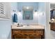 Cozy powder room with wooden cabinets, attractive mirror, and stylish fixtures at 3444 Briar Pl, Carmel, IN 46033
