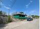 Side view of a weathered home with a narrow driveway, featuring a parked car at 3602 E 22Nd St, Indianapolis, IN 46218