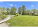Expansive backyard featuring lush lawn, mature trees, patio area, and wooden fencing at 3652 Newberry Rd, Plainfield, IN 46168