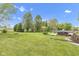 Picturesque backyard with mature trees, a fire pit, and a hot tub creating a serene outdoor oasis perfect for relaxation at 3652 Newberry Rd, Plainfield, IN 46168