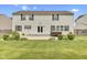 The rear of a two story house featuring a backyard with green lawn, patio and a hot tub at 3652 Newberry Rd, Plainfield, IN 46168