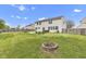 Beautifully landscaped backyard with a fire pit, green lawn, and privacy fence offering the perfect outdoor retreat at 3652 Newberry Rd, Plainfield, IN 46168