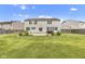 Expansive backyard featuring a well-maintained lawn, charming landscaping, and a relaxing hot tub on a concrete patio at 3652 Newberry Rd, Plainfield, IN 46168