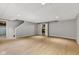 Finished basement showcasing laminate flooring, drop ceiling, closet, and neutral wall color at 3652 Newberry Rd, Plainfield, IN 46168