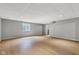 Finished basement with laminate flooring, drop ceiling, window, and neutral wall color at 3652 Newberry Rd, Plainfield, IN 46168