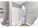 Bathroom showcasing a shower-tub combo with a decorative shower curtain and a toilet on the left at 3652 Newberry Rd, Plainfield, IN 46168