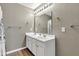Bathroom featuring a double sink vanity, large mirror with lighting, and neutral wall color at 3652 Newberry Rd, Plainfield, IN 46168