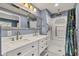 Well lit bathroom featuring double sinks with white cabinetry and a step in shower at 3652 Newberry Rd, Plainfield, IN 46168