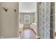 Bright bathroom featuring wood floors, a soaking tub, and a white double sink vanity at 3652 Newberry Rd, Plainfield, IN 46168