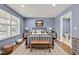 Cozy bedroom boasts a large window, wood floors, and an ensuite bathroom at 3652 Newberry Rd, Plainfield, IN 46168