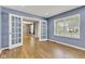 Spacious bedroom with hardwood floors, blue walls, and glass French doors, offering a versatile and stylish space at 3652 Newberry Rd, Plainfield, IN 46168