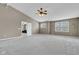 Large bedroom with vaulted ceilings, fan, and a view to another sitting area at 3652 Newberry Rd, Plainfield, IN 46168