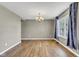 Open dining room with wood flooring, chandelier, and window providing natural light at 3652 Newberry Rd, Plainfield, IN 46168