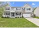 Two-story home boasts a brick and vinyl facade, attached two-car garage, well-kept lawn, and charming front porch at 3652 Newberry Rd, Plainfield, IN 46168