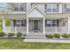 Inviting front porch features white columns, brick accents, and green shutters for a classic curb appeal at 3652 Newberry Rd, Plainfield, IN 46168