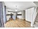 Open kitchen and living space with hardwood floors, kitchen island, and modern appliances at 3652 Newberry Rd, Plainfield, IN 46168