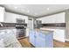 Modern kitchen with stainless steel appliances, granite countertops, a stylish island, and hardwood floors at 3652 Newberry Rd, Plainfield, IN 46168