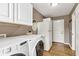 Bright laundry room with washer, dryer, and ample storage space, including a refrigerator at 3652 Newberry Rd, Plainfield, IN 46168