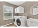 Functional laundry room with washer, dryer, utility sink, and storage cabinets at 3652 Newberry Rd, Plainfield, IN 46168
