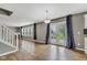 Open living room with hardwood floors, fireplace, and large French doors leading to outdoor space at 3652 Newberry Rd, Plainfield, IN 46168