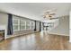 Open living room with wood floors, fireplace, and kitchen in the background at 3652 Newberry Rd, Plainfield, IN 46168
