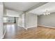 Open living room with hardwood floors, neutral paint, and natural light from the window, providing a versatile space at 3652 Newberry Rd, Plainfield, IN 46168
