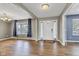 Open living room with hardwood floors, neutral paint, and natural light from the window, providing a versatile space at 3652 Newberry Rd, Plainfield, IN 46168