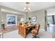 Well-lit home office with hardwood desk, comfortable chair and neutral walls at 3652 Newberry Rd, Plainfield, IN 46168