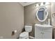 This is a half bath offering a sink, commode and mirror at 3652 Newberry Rd, Plainfield, IN 46168