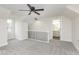 A cozy bedroom features a ceiling fan, neutral walls, plush carpet, and an en suite bathroom for ultimate comfort at 3845 Cornelius Ave, Indianapolis, IN 46208