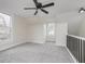 Upstairs bedroom boasts neutral carpet, white walls and trim, and several windows at 3845 Cornelius Ave, Indianapolis, IN 46208