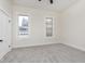 Cozy bedroom with neutral carpet, white trim and walls, and natural light from two windows at 3845 Cornelius Ave, Indianapolis, IN 46208
