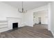 Living room featuring a classic fireplace and an open concept to other rooms at 3845 Cornelius Ave, Indianapolis, IN 46208