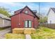 Exterior of a red home with a newly-constructed wood deck, french doors, and green lawn at 400 N Sycamore St, Martinsville, IN 46151