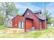 Exterior of a red home featuring a small wooden deck and green lawn at 400 N Sycamore St, Martinsville, IN 46151