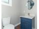 Bathroom features a stylish blue vanity with marble countertop, modern mirror, and neutral walls at 400 N Sycamore St, Martinsville, IN 46151
