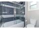 Modern bathroom showcasing a sleek glass shower door, stylish tiled walls, and modern toilet and fixtures at 400 N Sycamore St, Martinsville, IN 46151