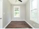 Bedroom boasts dark hardwood floors, fresh paint, a modern ceiling fan, and ample natural light from two windows at 400 N Sycamore St, Martinsville, IN 46151
