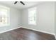 Cozy bedroom featuring two bright windows, a ceiling fan, and ample natural light at 400 N Sycamore St, Martinsville, IN 46151