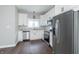 Updated kitchen featuring white cabinets, stainless steel appliances, granite counters, and hardwood floors at 400 N Sycamore St, Martinsville, IN 46151