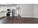 Open floor plan showcasing the kitchen with stainless steel appliances and modern white cabinetry at 400 N Sycamore St, Martinsville, IN 46151