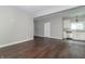 Open floor plan of the spacious living room featuring fresh paint and dark hardwood floors at 400 N Sycamore St, Martinsville, IN 46151