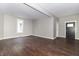 Spacious open floor plan featuring hardwood floors, a black front door, and ample natural light at 400 N Sycamore St, Martinsville, IN 46151