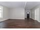 Spacious room with hardwood floors, freshly painted walls, ample natural light, and a black front door at 400 N Sycamore St, Martinsville, IN 46151