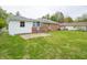 View of the backyard with patio, lawn, and the home's brick and white exterior at 4029 N Euclid Ave, Indianapolis, IN 46226