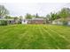 Expansive backyard featuring a well-maintained lawn and brick exterior of the home at 4029 N Euclid Ave, Indianapolis, IN 46226
