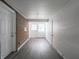 Unfinished basement with painted brick, concrete walls, gray vinyl floors, and access to a door to the exterior at 4029 N Euclid Ave, Indianapolis, IN 46226