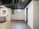 Updated basement with a modern vanity, vinyl flooring, and exposed plumbing at 4029 N Euclid Ave, Indianapolis, IN 46226