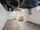 Updated basement with vinyl flooring, modern lighting and bathroom vanity at 4029 N Euclid Ave, Indianapolis, IN 46226